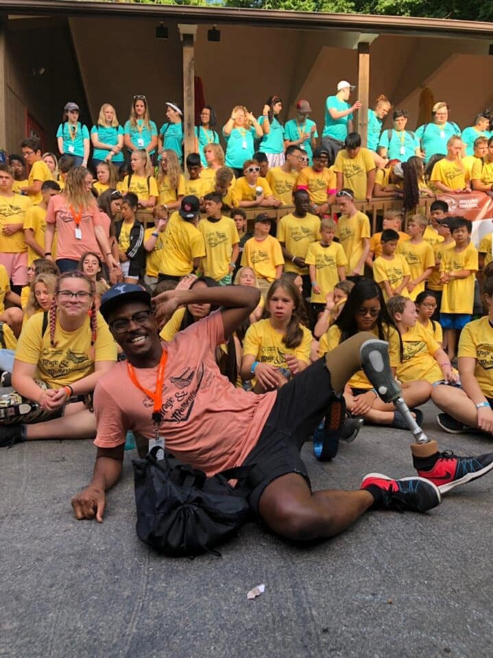Ty poses with a large group of campers and counselors at the Inclusive Arts Camp