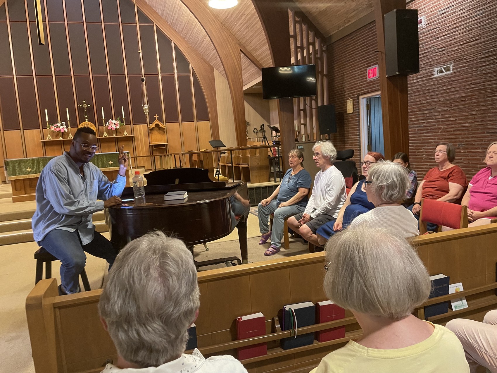 Ty leading a storytelling and music workshop with a diverse community group